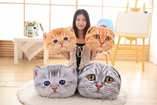 Person with four large cat-shaped cushions with a neutral background