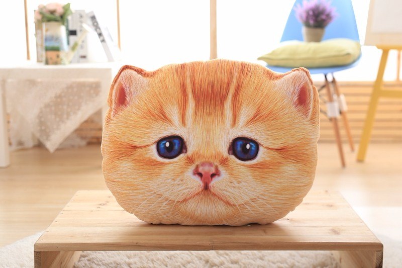 Cat-shaped cushion on a wooden table with a blurred indoor background