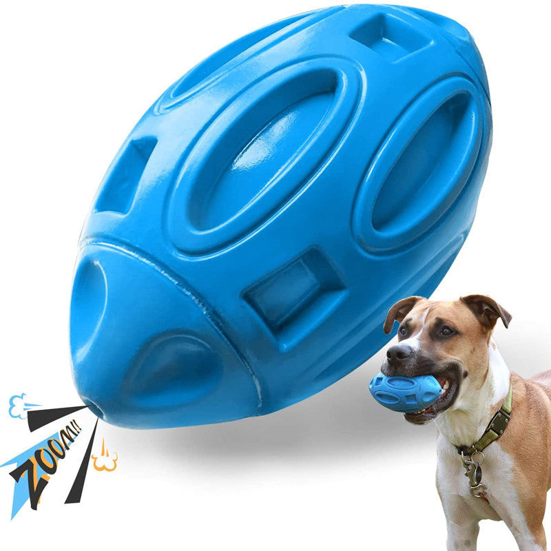 Blue rubber squeaky rugby ball dog toy with Staffordshire Bull Terrier holding it in mouth