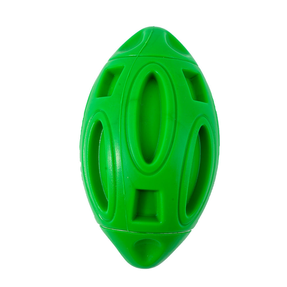 Green rubber squeaky rugby ball dog toy with hollow cutout design for aggressive chewers