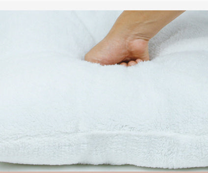 Foot stepping onto a white towel