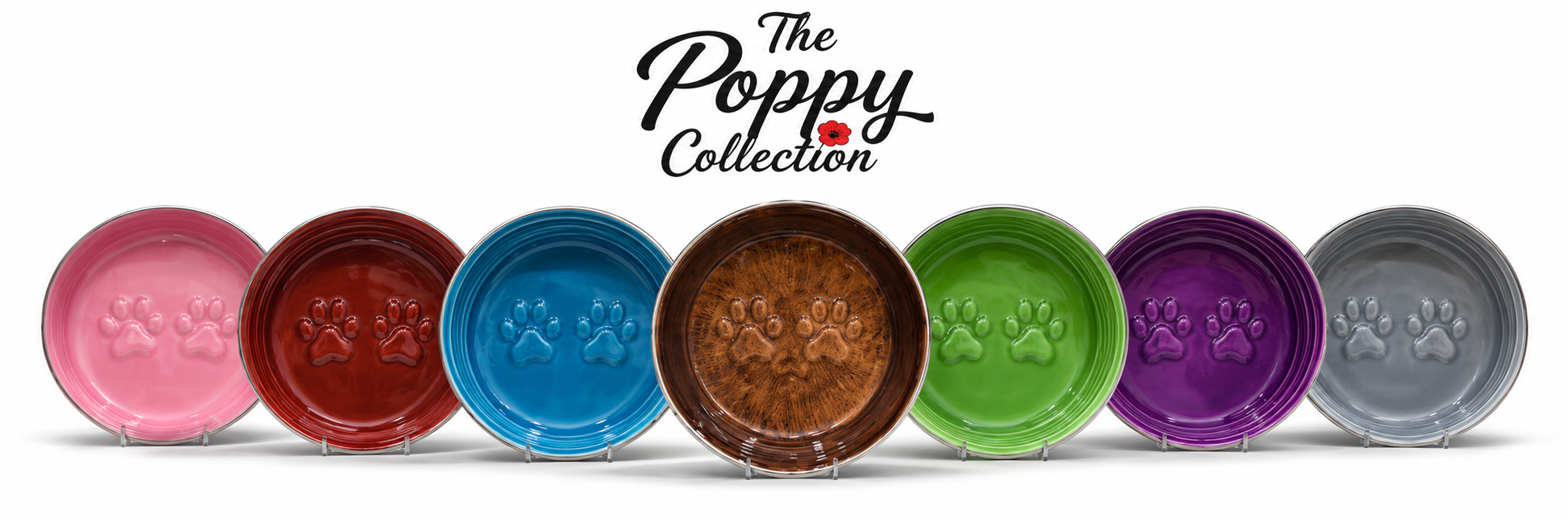 Seven round pet bowls in pink, red, blue, brown, green, purple, and gray, lined up in a row on a white background with 'The Poppy Collection' logo above them.